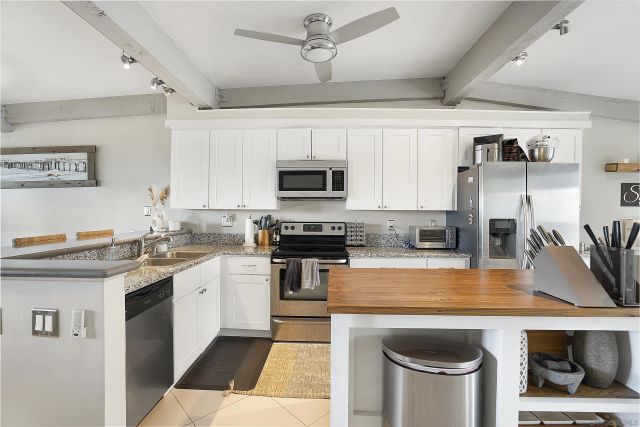 a kitchen with stainless steel appliances granite countertop a stove and cabinets