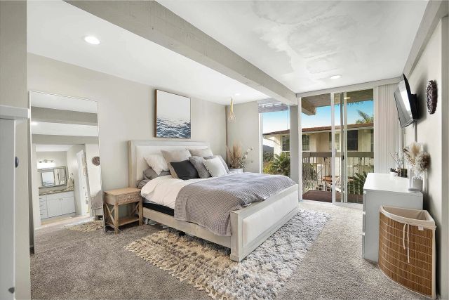 a bedroom with a large bed and a flat screen tv