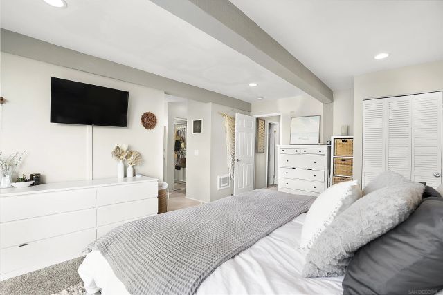 a bedroom with a bed and a large mirror