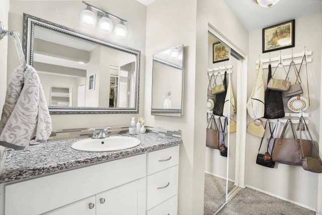 a view of a house with a small yard and potted plants