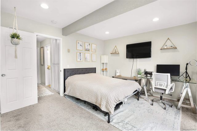 a bedroom with a bed a table and chair