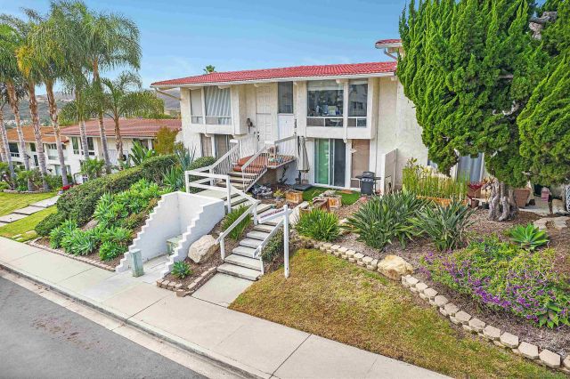 a view of a house with backyard sitting area and garden
