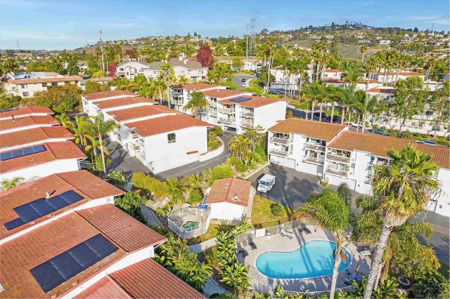 an aerial view of residential houses with outdoor space
