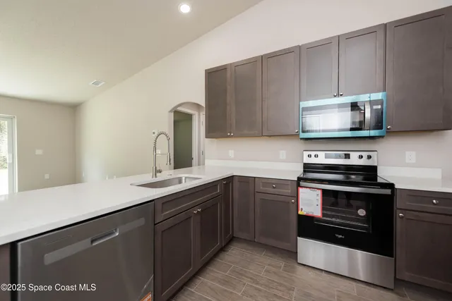 a kitchen with a sink and a stove top oven