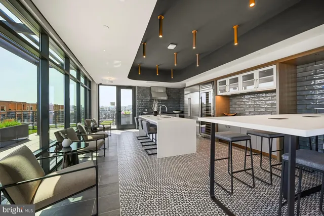 a kitchen with a large window and dining table