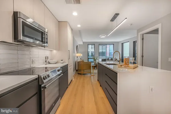 a open kitchen with stainless steel appliances kitchen island granite countertop a sink and cabinets