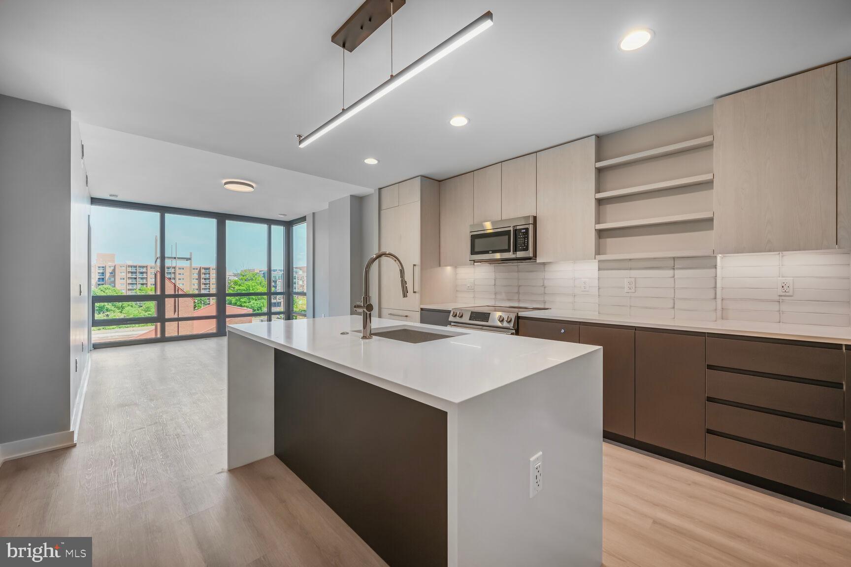 950 3rd Street Northwest, Unit 302 Washington, DC 20001 - Photo 35 of 36 a kitchen with a sink stove and cabinets