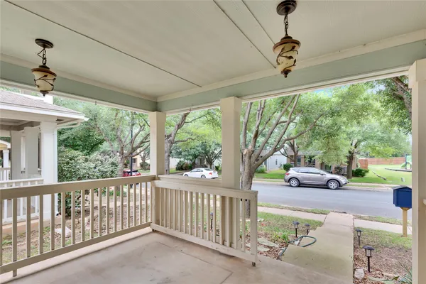 a view of a porch with furniture and a yard