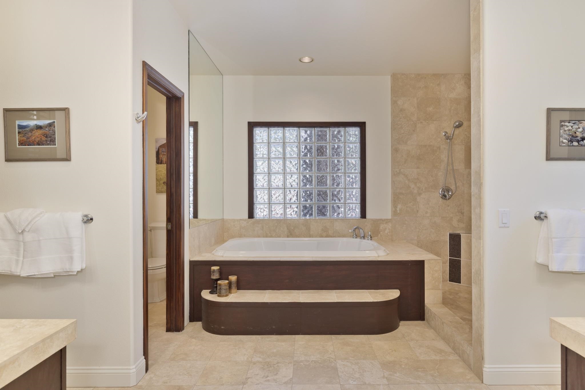 378 Ridge Way Mammoth Lakes, CA 93546 - Photo 25 of 43 Bathroom with a built-in soaking tub, glass block window, and tile-surround shower