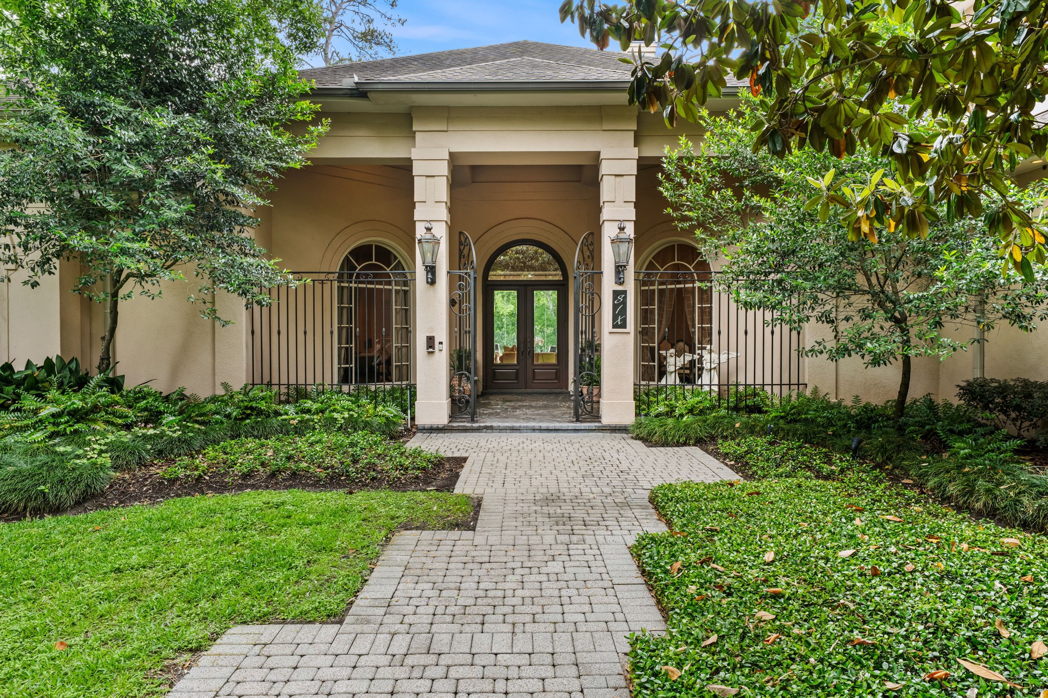 6 Mott Lane Houston, TX 77024 - Photo 3 of 50 Mediterranean-style facade with updated pavers and gas laterns.