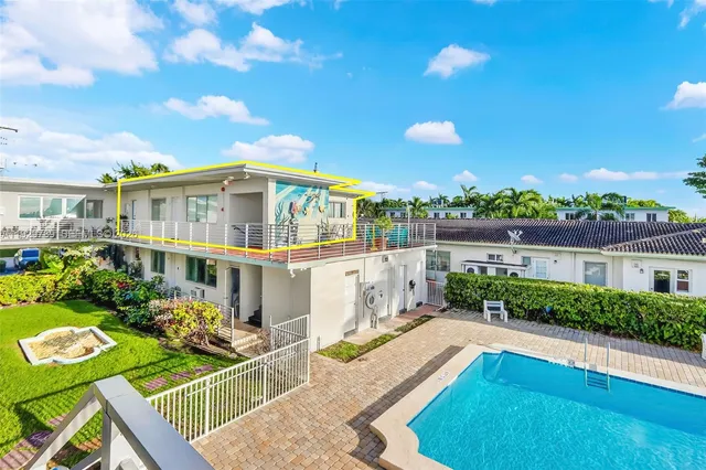 a view of a house with swimming pool and sitting area