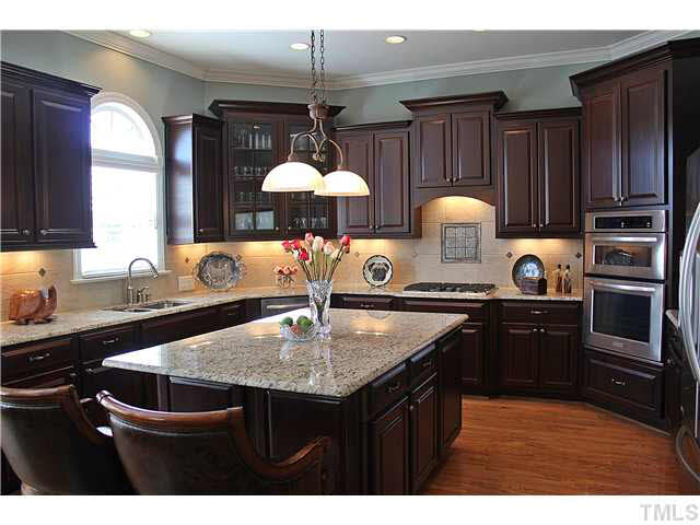 11826 Lowery Ridge Drive Raleigh, NC 27614 - Photo 10 of 25 Granite, S/S appliances, ceramic back splash, gas cooktop great center island are just some of the standout features of this kitchen.