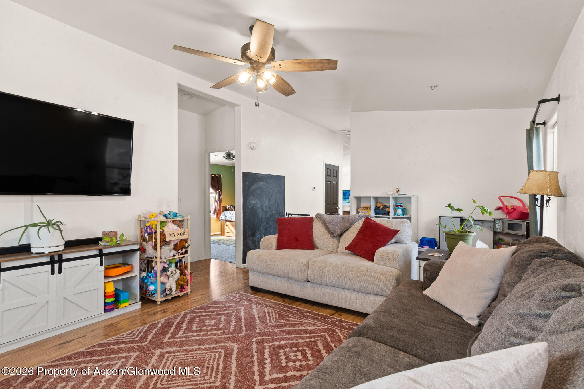 106 Cedar Circle Parachute, CO 81635 - Photo 13 of 35 a living room with furniture and a flat screen tv