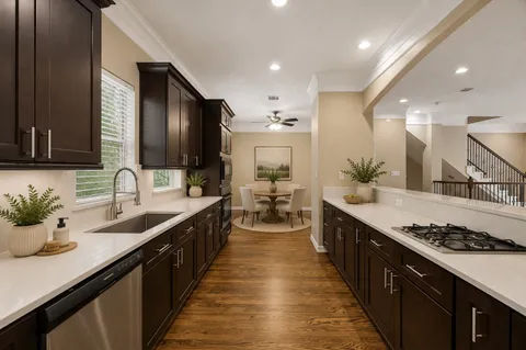 a kitchen with stainless steel appliances a refrigerator and a stove top oven