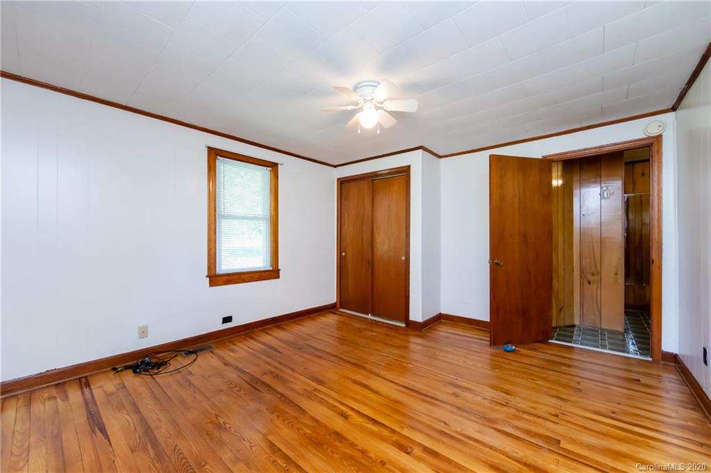 4480 Needmore Road Woodleaf, NC 27054 - Photo 6 of 15 a view of an empty room with window and wooden floor
