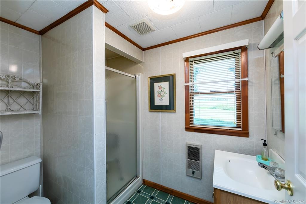 4480 Needmore Road Woodleaf, NC 27054 - Photo 9 of 15 a bathroom with a sink and a mirror