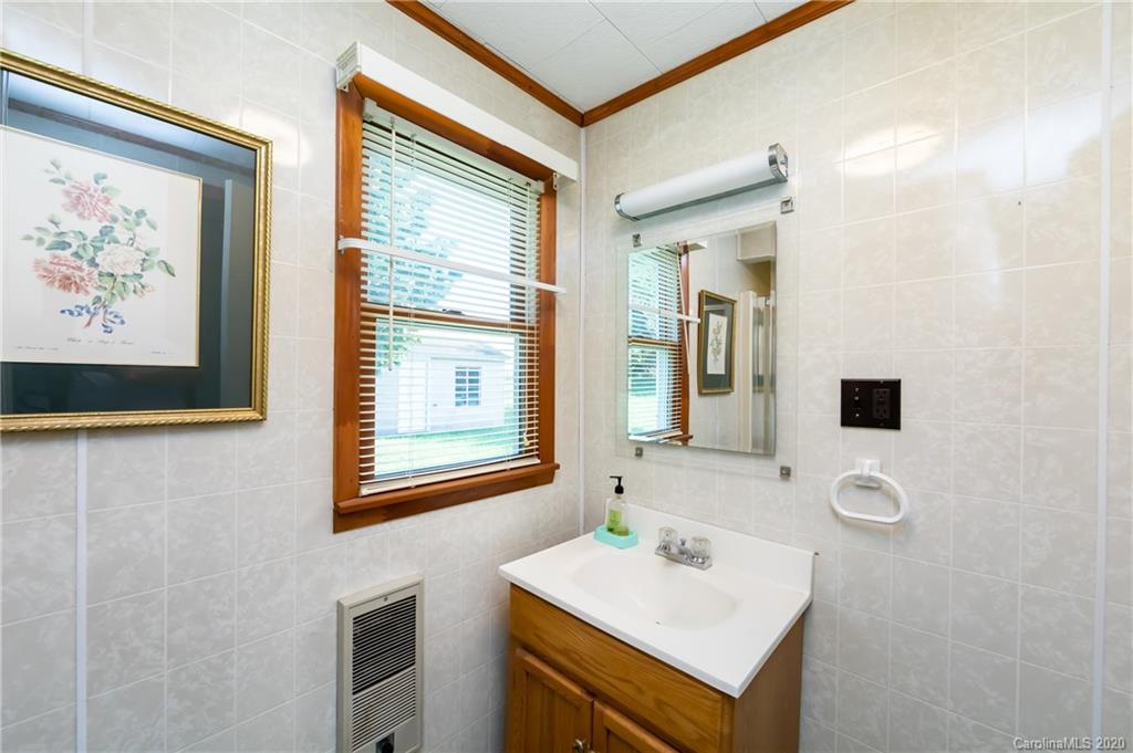 4480 Needmore Road Woodleaf, NC 27054 - Photo 10 of 15 a bathroom with a sink and a mirror