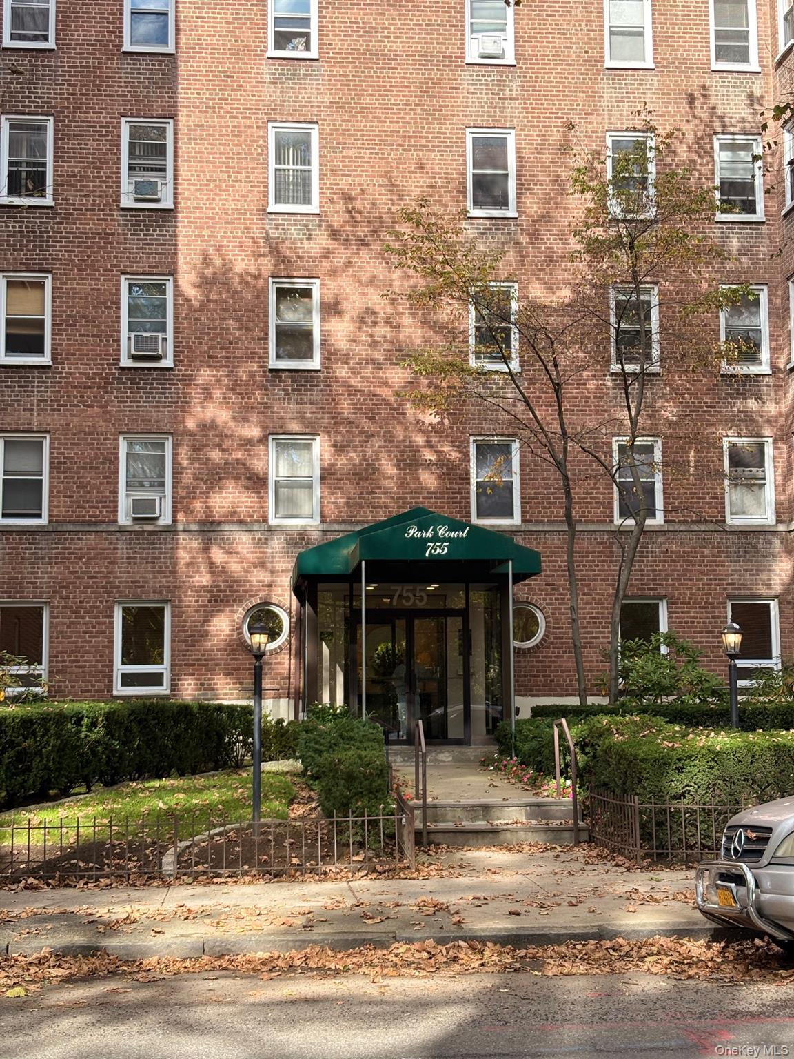 755 Bronx River Road, Unit 6E Bronxville, NY 10708 - Photo 1 of 1 a front view of a brick house with a yard