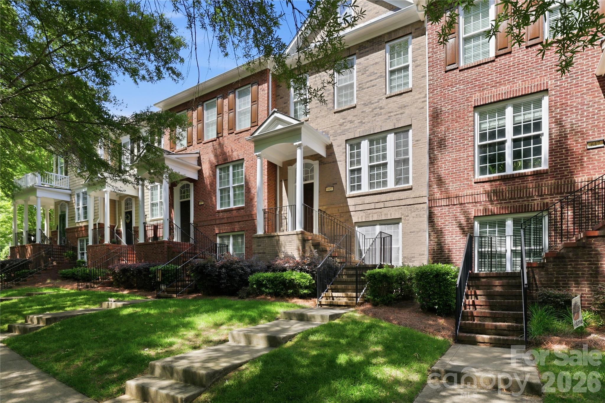 645 6th Baxter Crossing Fort Mill, SC 29708 - Photo 26 of 32 a view of a brick building next to a yard