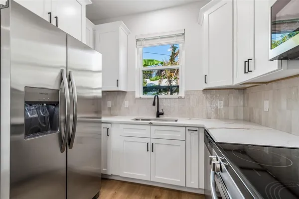 a kitchen with appliances cabinets and a sink