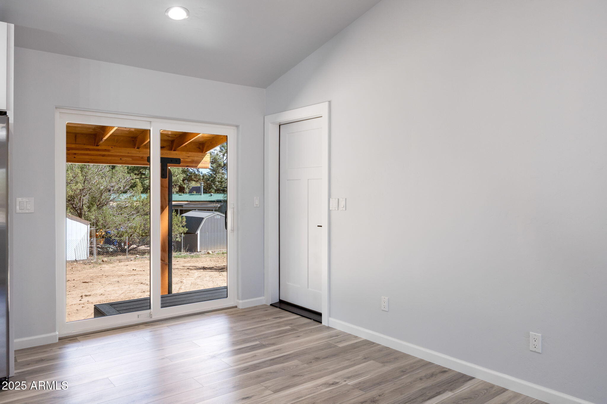 1982 Christmas Pine Road Overgaard, AZ 85933 - Photo 13 of 34 a view of an empty room with wooden floor and a window