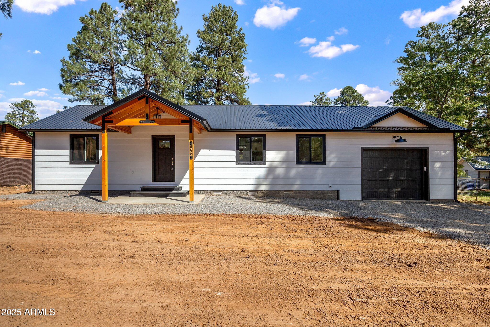 1982 Christmas Pine Road Overgaard, AZ 85933 - Photo 3 of 34 a front view of a house with a yard and garage
