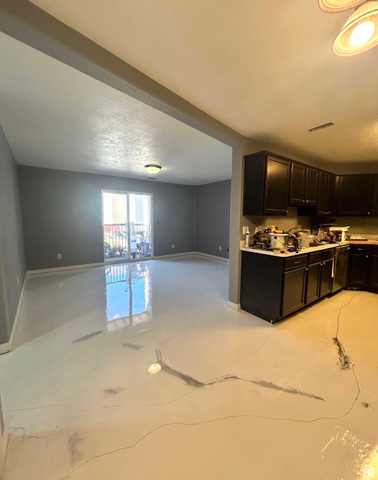 8116 North Ridge Loop West, Unit 8 Eagle Mountain, UT 84005 - Photo 23 of 23 Kitchen with light countertops, open floor plan, and dark cabinetry