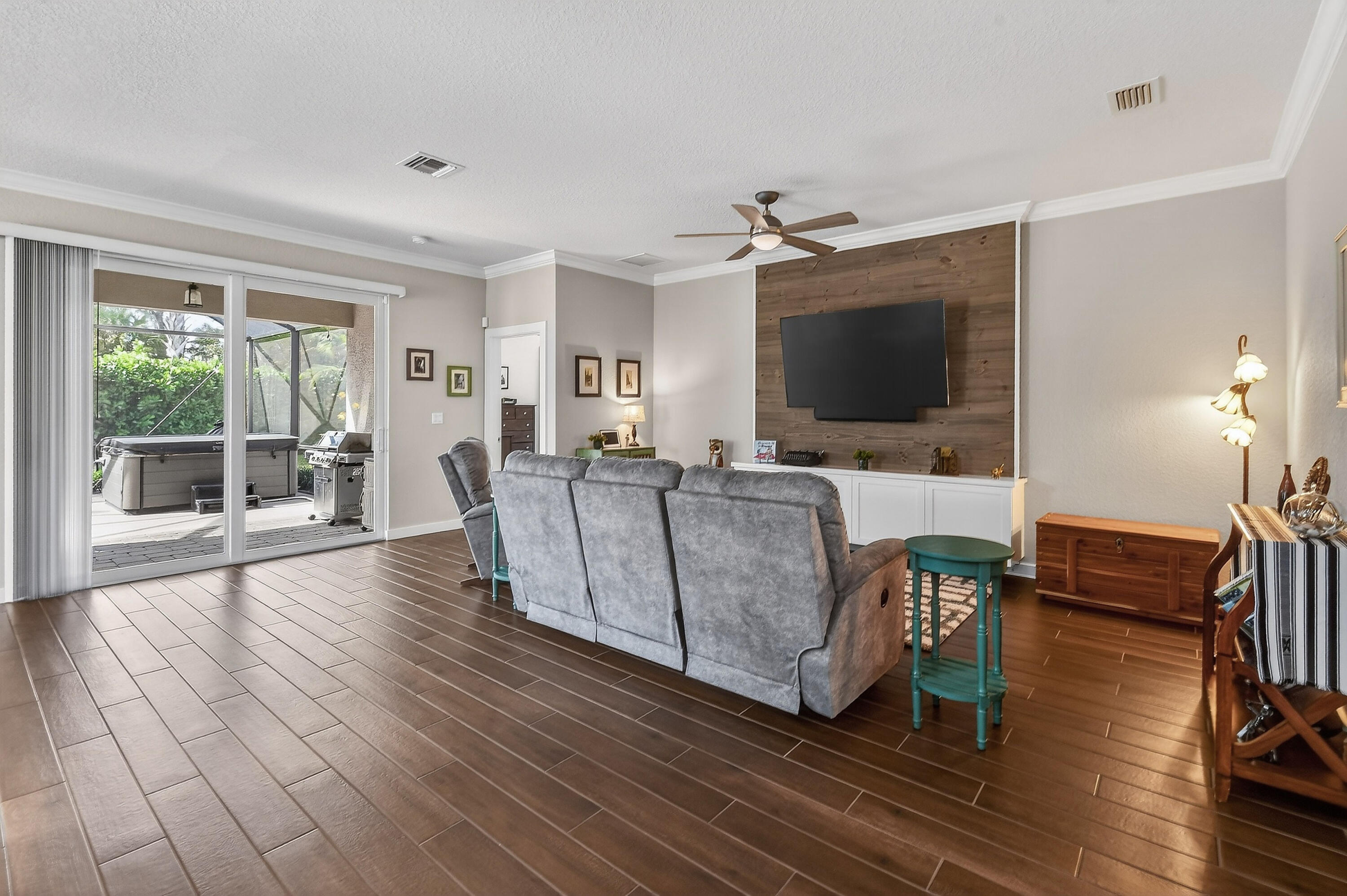 7561 Southwest Harbor Cove Drive Stuart, FL 34997 - Photo 13 of 62 a living room with furniture and a flat screen tv