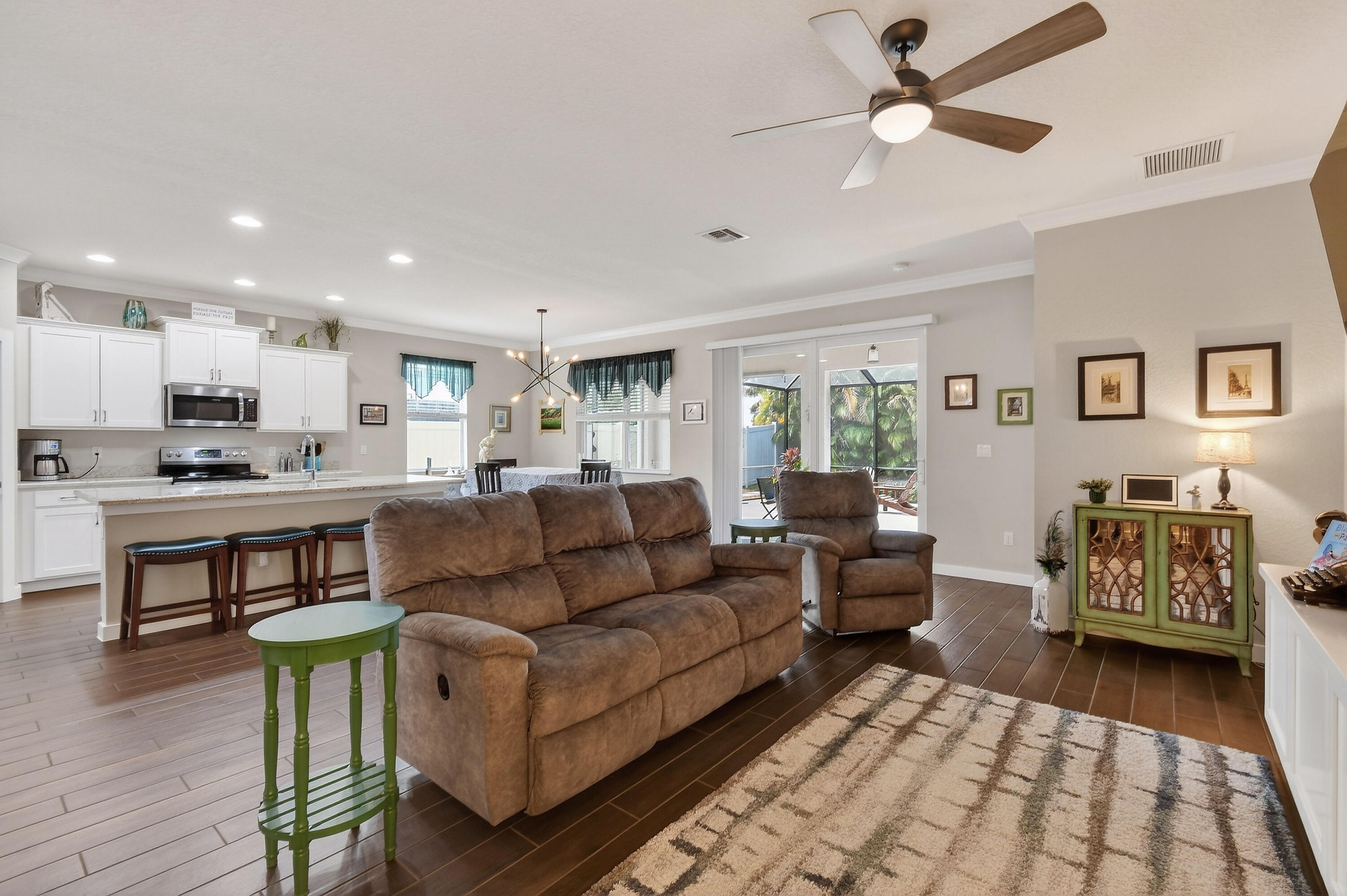 7561 Southwest Harbor Cove Drive Stuart, FL 34997 - Photo 17 of 62 a living room with furniture and a dining table with wooden floor