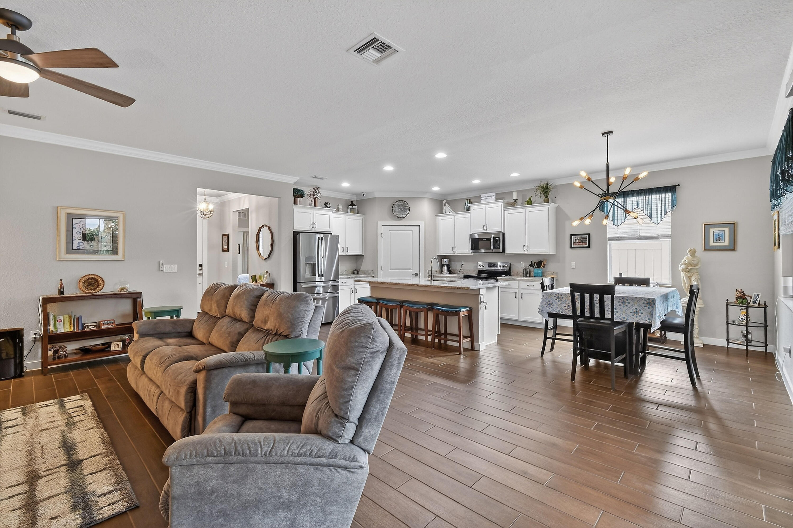 7561 Southwest Harbor Cove Drive Stuart, FL 34997 - Photo 18 of 62 a living room with furniture and kitchen view