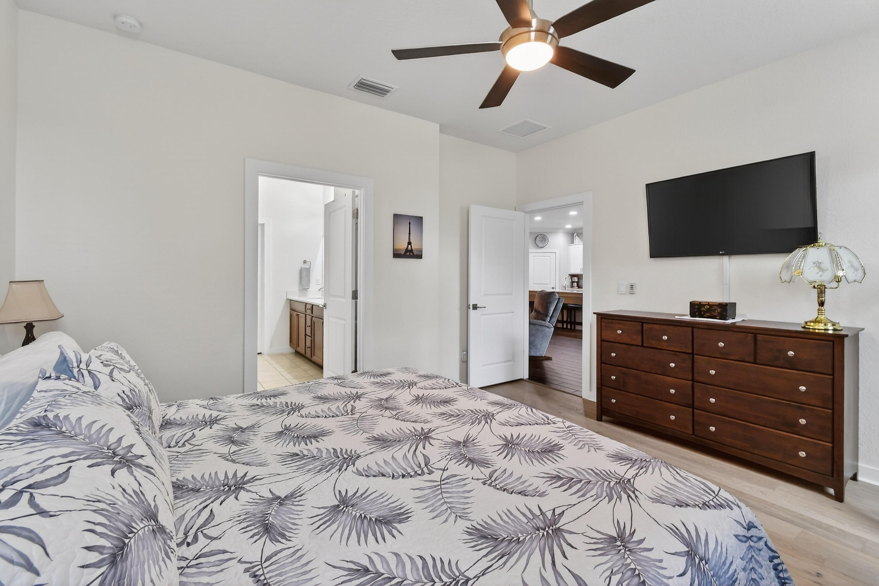 7561 Southwest Harbor Cove Drive Stuart, FL 34997 - Photo 33 of 62 a bedroom with a bed and a flat screen tv