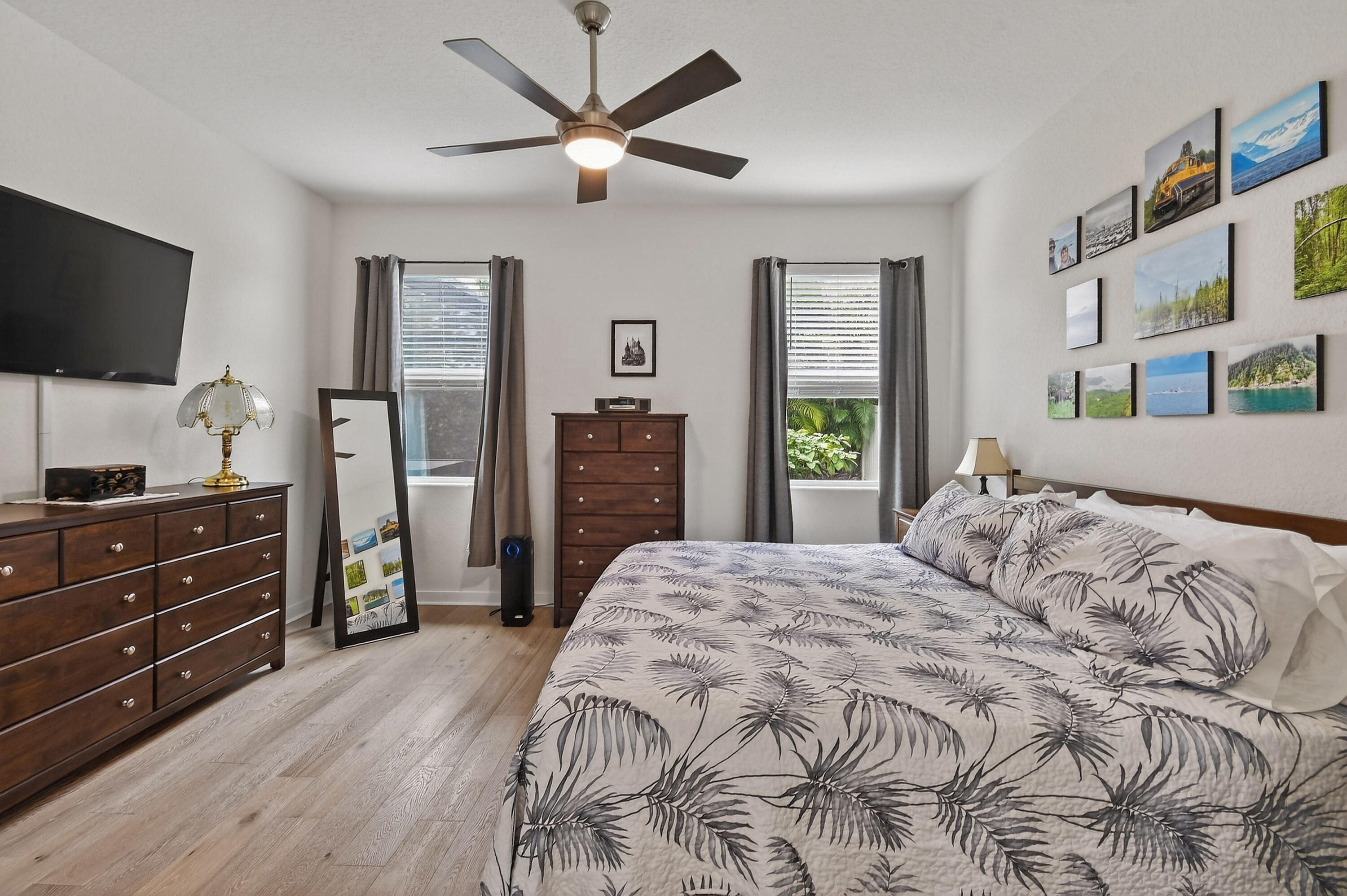 7561 Southwest Harbor Cove Drive Stuart, FL 34997 - Photo 34 of 62 a bedroom with a bed and a flat screen tv