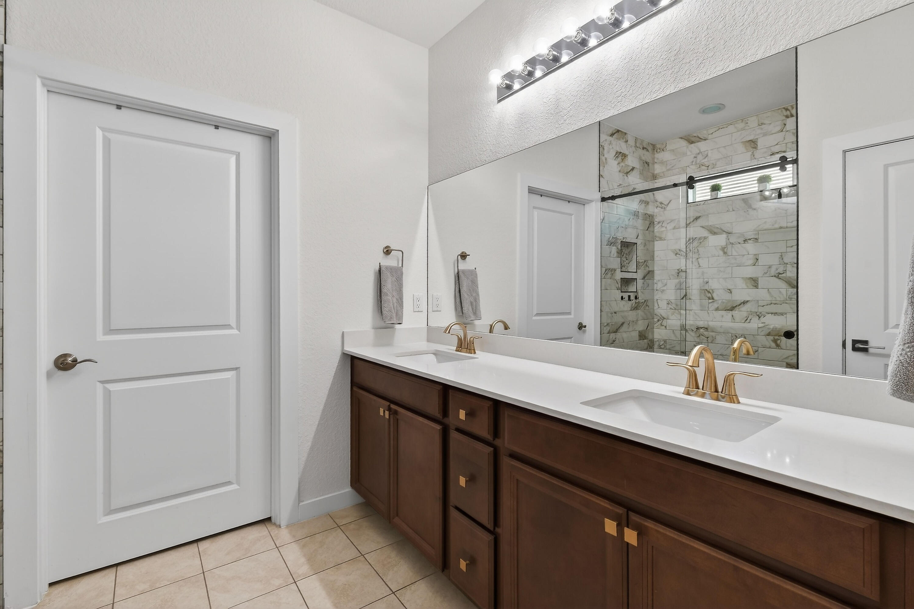 7561 Southwest Harbor Cove Drive Stuart, FL 34997 - Photo 36 of 62 a bathroom with a double vanity sink a and mirror