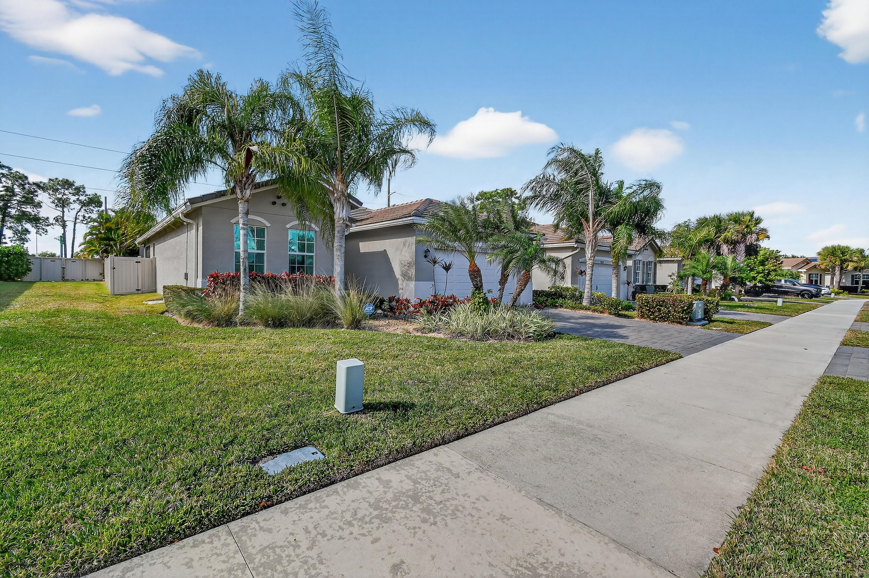 7561 Southwest Harbor Cove Drive Stuart, FL 34997 - Photo 60 of 62 a front view of house with yard and green space