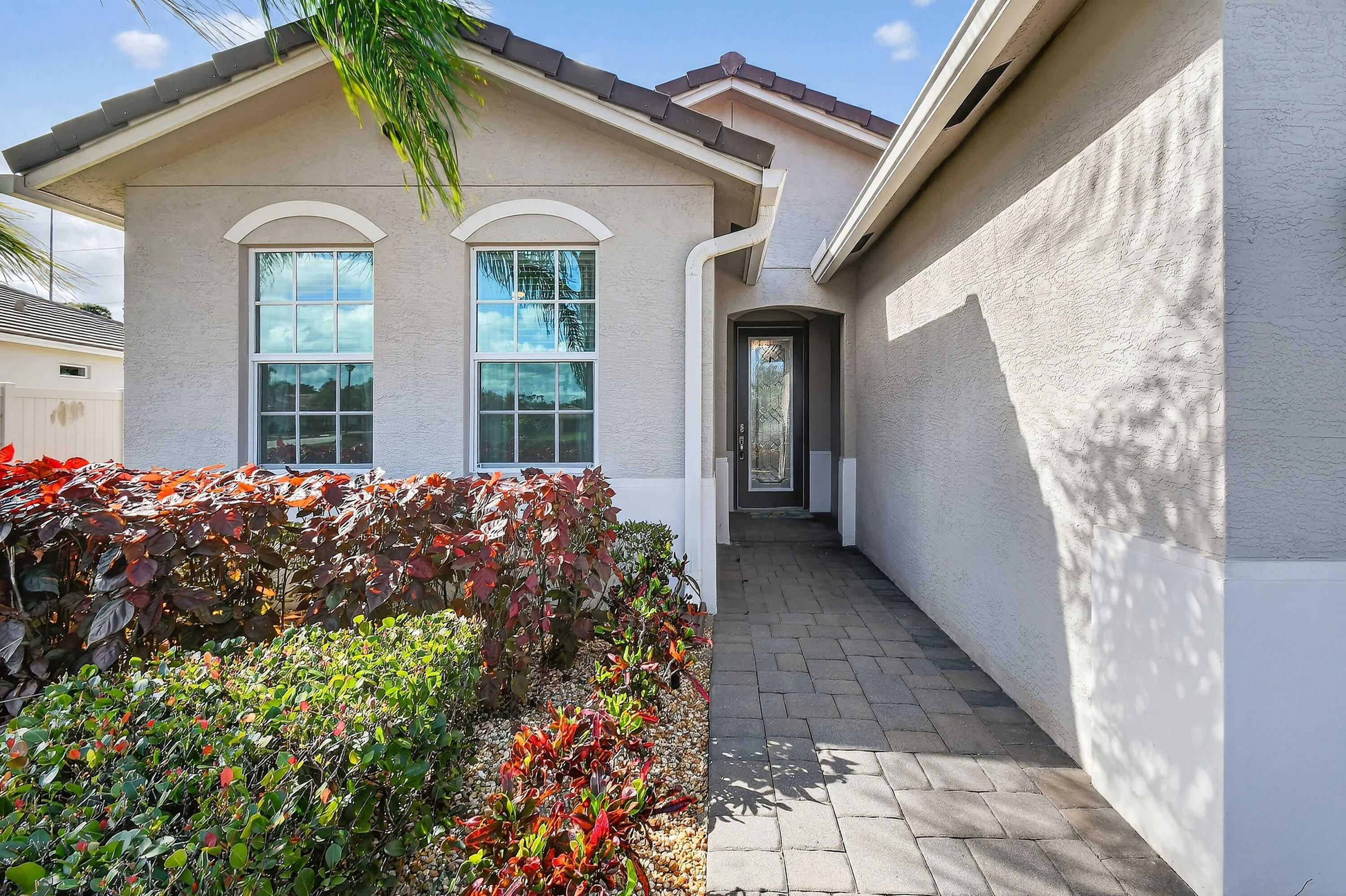 7561 Southwest Harbor Cove Drive Stuart, FL 34997 - Photo 7 of 62 a front view of a house with a garden