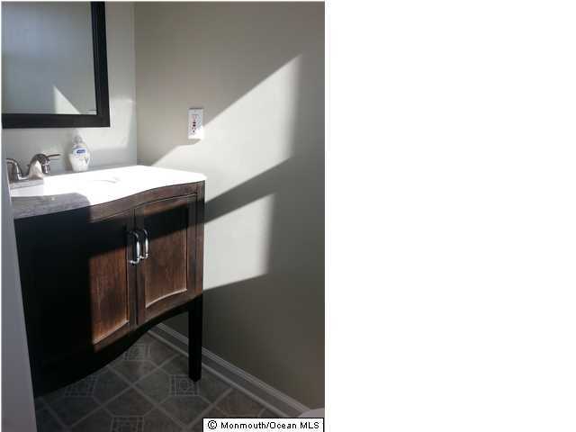 252 Cottrell Road Old Bridge, NJ 08857 - Photo 16 of 19 a kitchen with a sink and a mirror