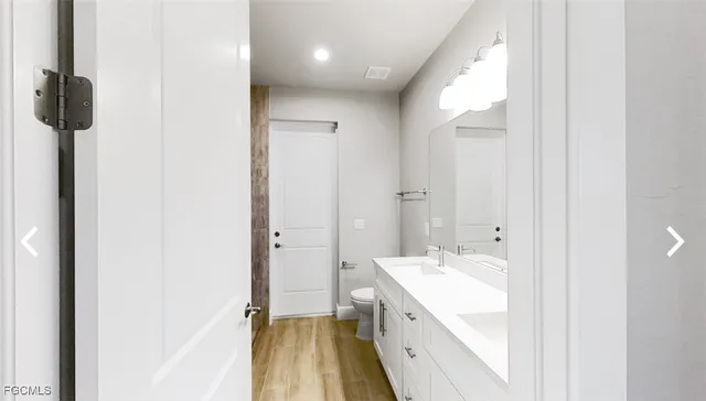 a spacious bathroom with a double vanity sink and mirror