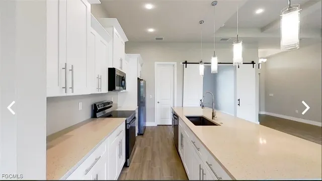 a large white kitchen with a large window