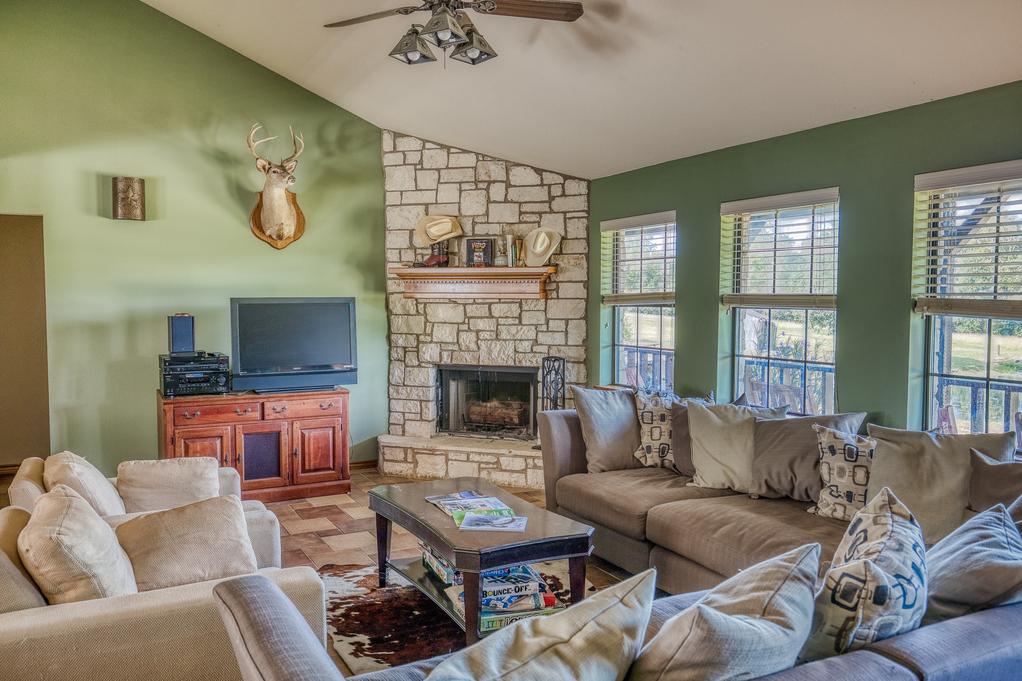 515 East Sh 543 Loop West Point, TX 78963 - Photo 12 of 36 a living room with furniture ceiling fan and a fireplace