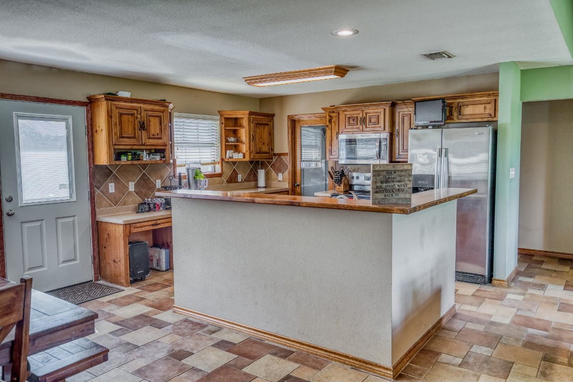 515 Highway 543 Loop West Point, TX 78963 - Photo 30 of 37 a kitchen with stainless steel appliances granite countertop a stove a sink and a refrigerator