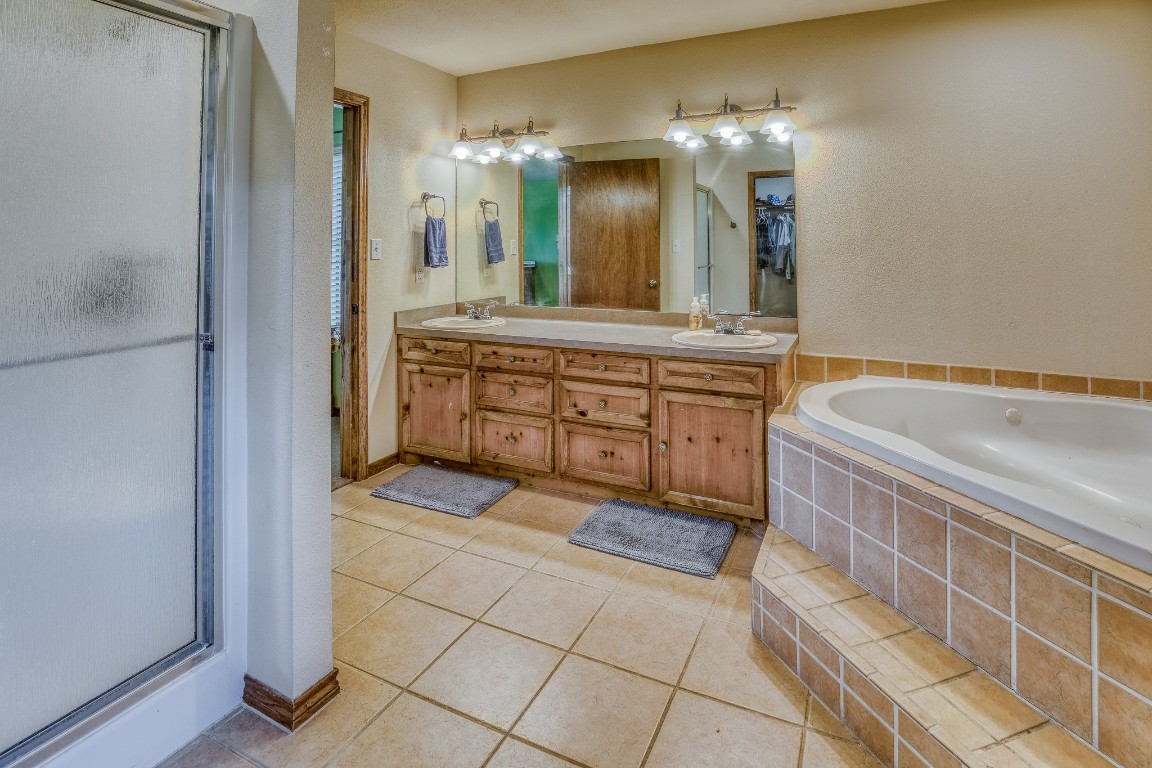 515 Highway 543 Loop West Point, TX 78963 - Photo 32 of 37 a spacious bathroom with a sink a vanity and a mirror