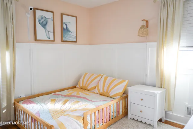 a bedroom with a bed and lamp