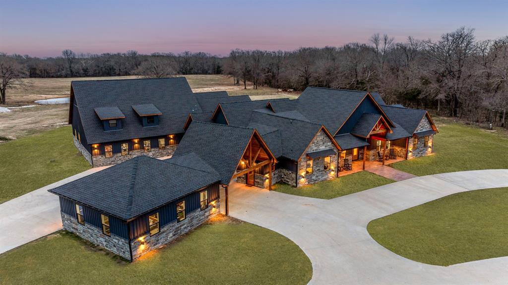 an aerial view of a house having yard patio and mountain view