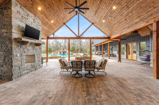 a spacious bathroom with a granite countertop sink a toilet and a mirror