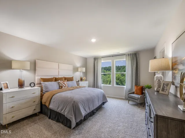 a en suite bathroom with a double vanity sink a mirror and shower