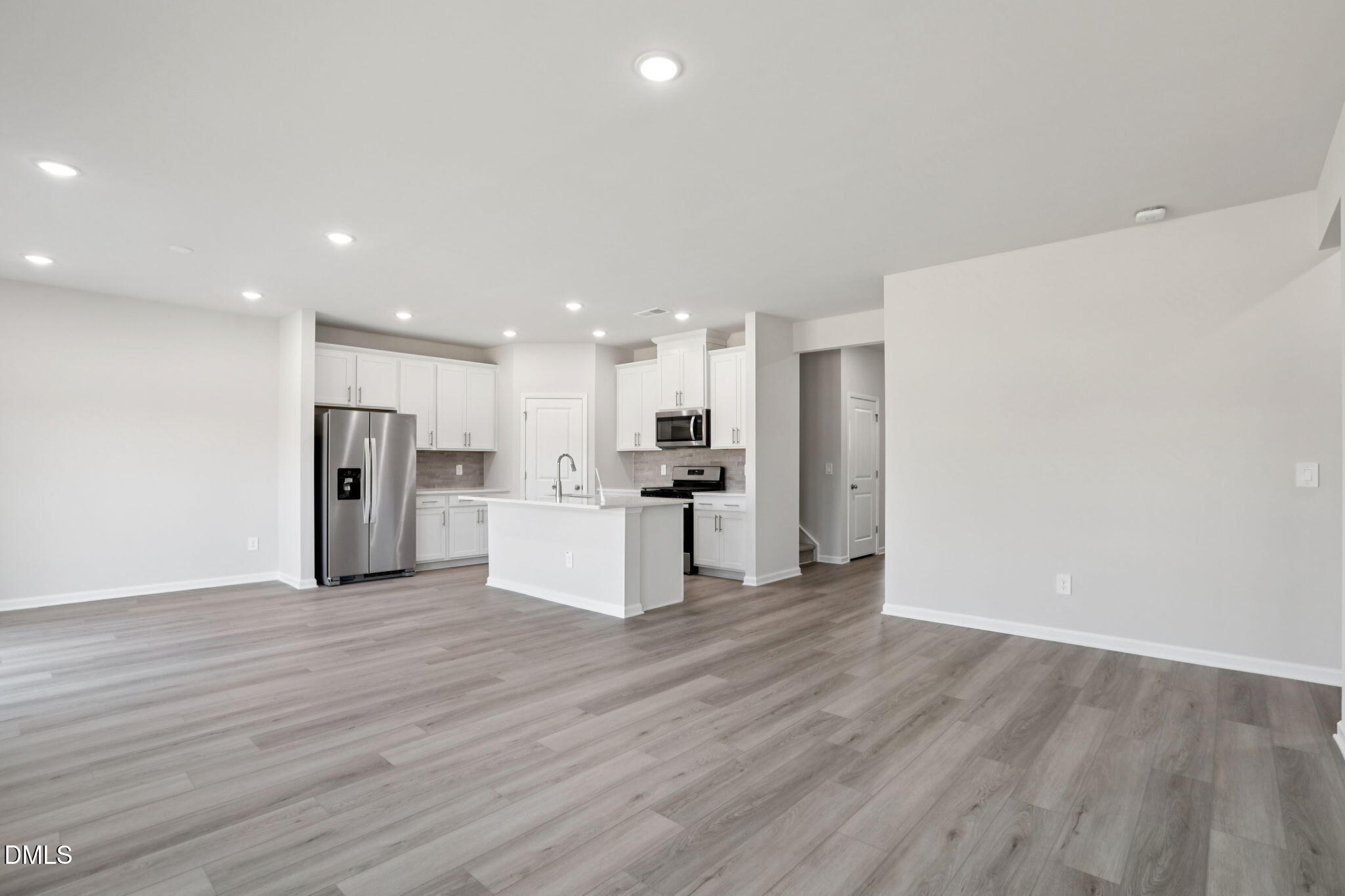 36 Hoff Court Angier, NC 27501 - Photo 12 of 43 a view of kitchen with kitchen island wooden floor center island and stainless steel appliances