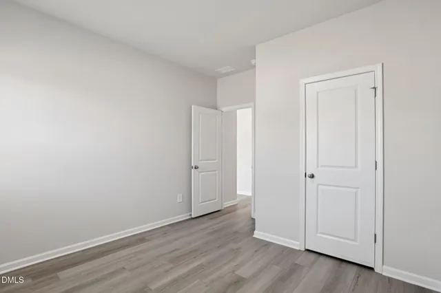 a view of an empty room and wooden floor