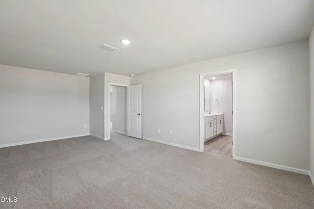 a view of an empty room and closet area