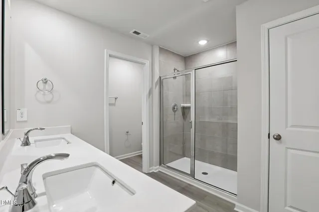 a bathroom with a shower and sink