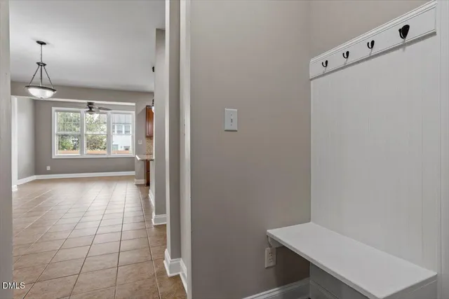 a view of a hallway with an empty room and a window